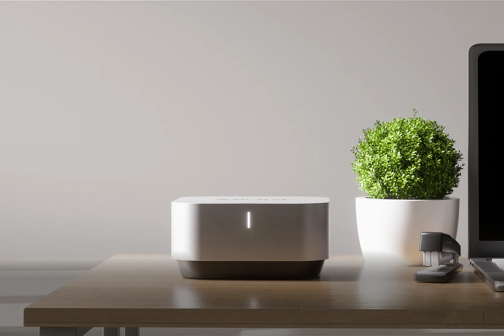 Omna autonomous AI hardware unit on a wooden desk with power indicator light