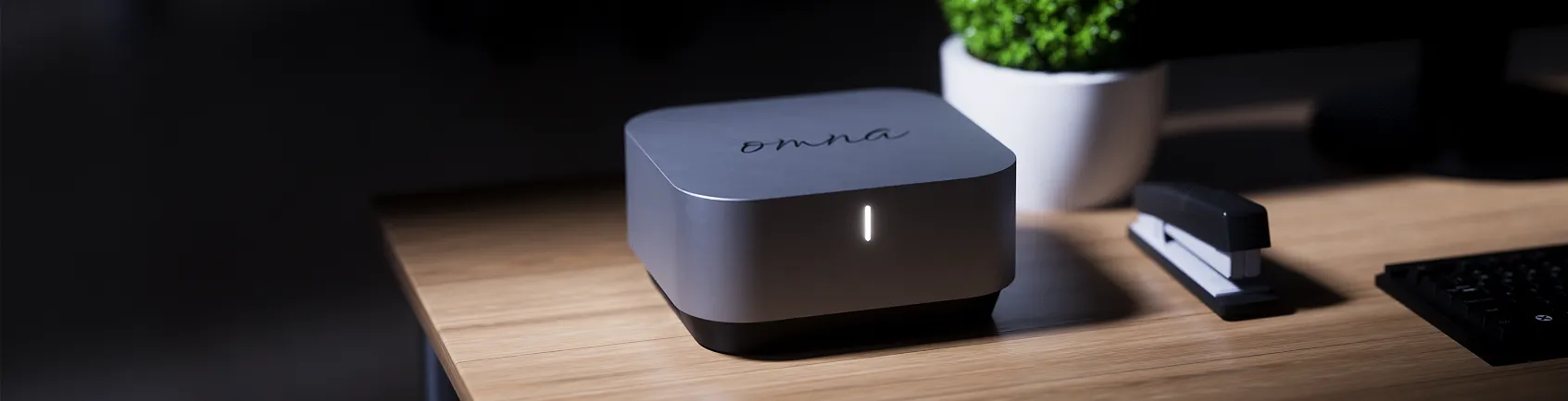Omna pricing banner showcasing office desk and keyboard